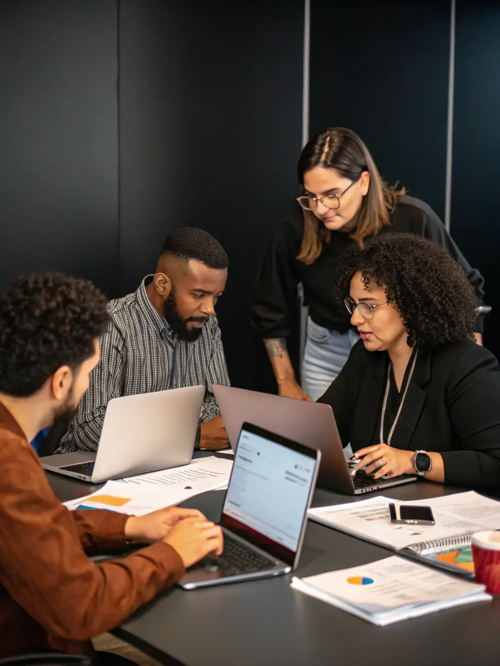 A professional photograph showcasing the DigiTransform team collaborating in a modern office environment, symbolizing their teamwork and dedication to achieving client results.